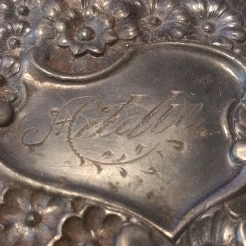 Vintage silver hand held mirror with raised flowers